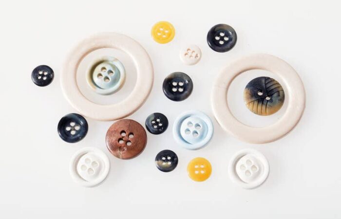 Recycled acetate buttons produced from cigarette filters, offering a sustainable material for fashion and eyewear.